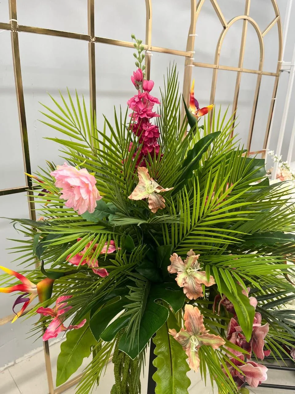 Colorful garden party floral arrangement rental with tropical greenery OKC